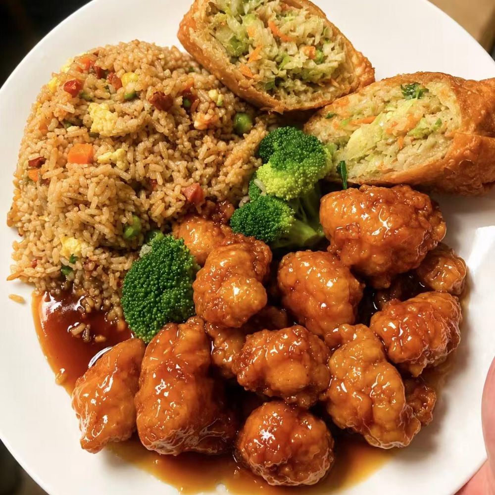 Platter of orange sauce chickenshrimp, fried rice, and cut spring rolls Platter of orange sauce chickenshrimp, fried rice, and cut spring rolls