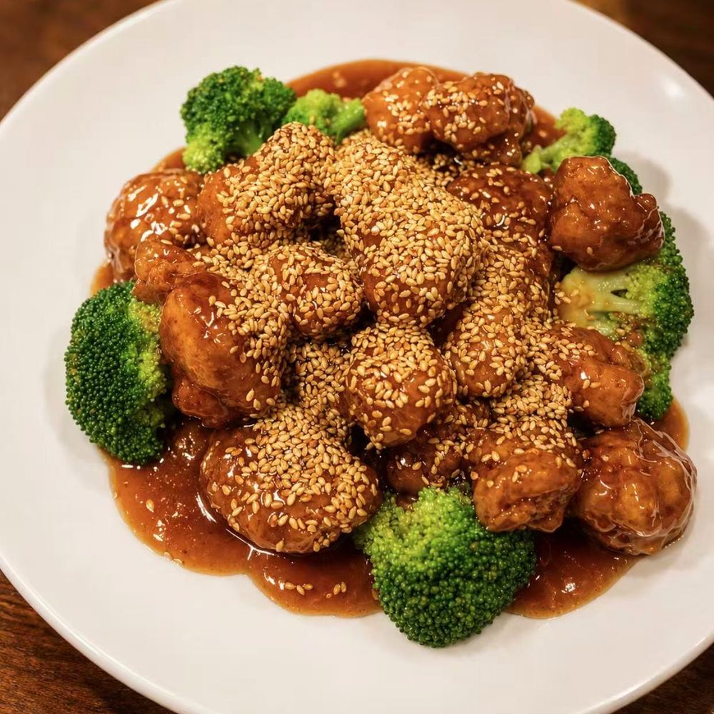Sesame chicken with broccoli in a thick sauce and sesame seeds Sesame chicken with broccoli in a thick sauce and sesame seeds