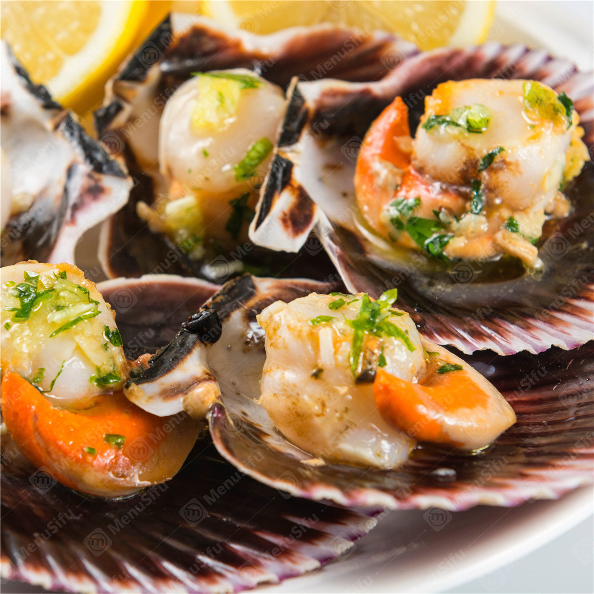 Garlic butter grilled scallops in shells with fresh lemon wedges at Rock Seafood and Fried Crabhouse, a Seafood Restaurant in Baltimore