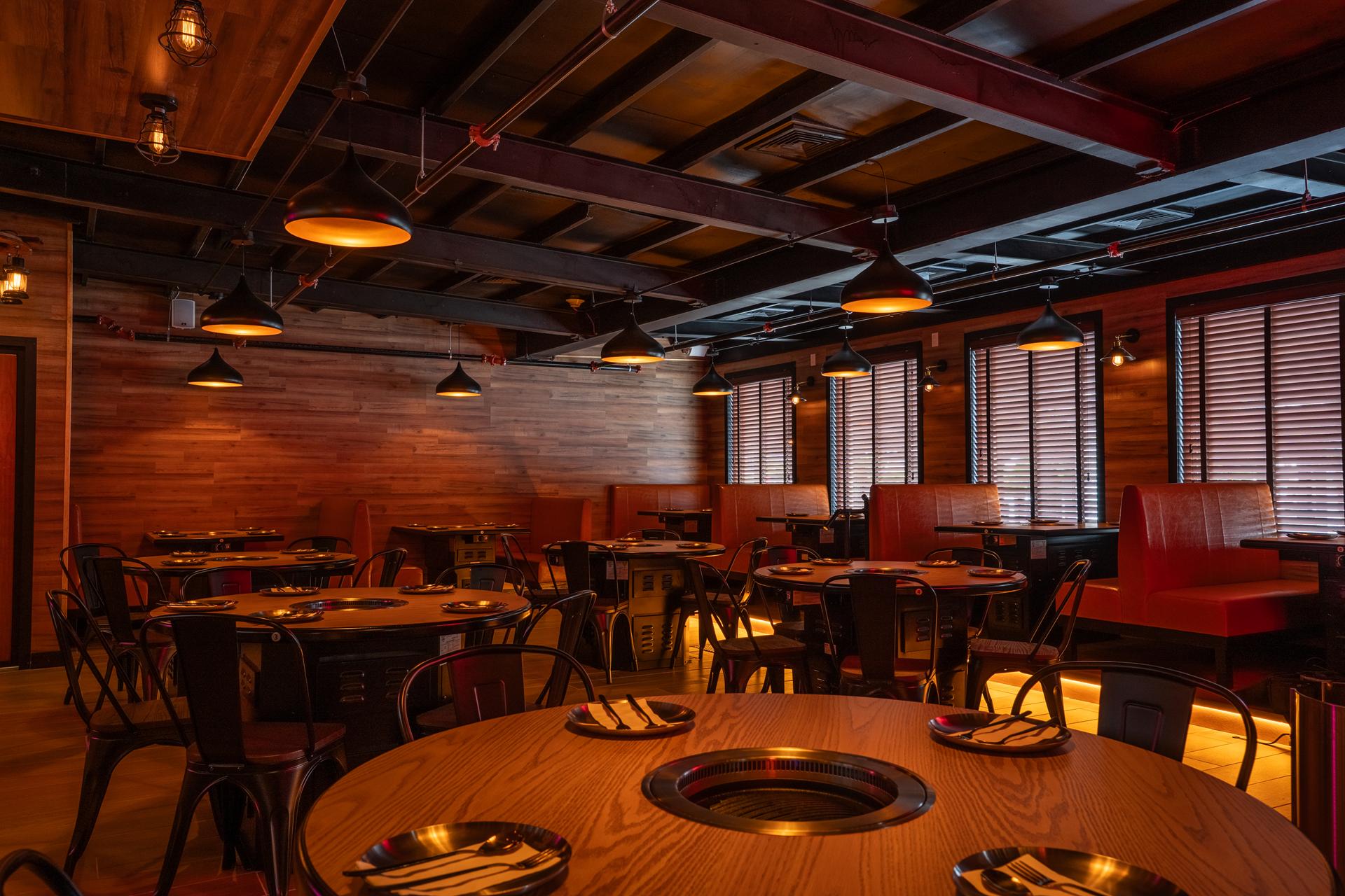 Cozy Korean BBQ Restaurant Interior with Wooden Tables and Built-In Grills