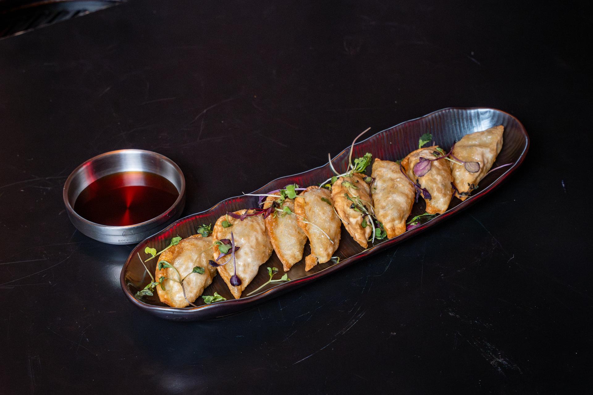 Pan Fried Dumplings With Dipping Sauce from Rockstar Korean Bbq Chicken, a Korean Style Barbecue Restaurant in Valley Stream