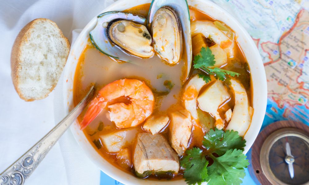 Spicy seafood soup with mussels, shrimp, and herbs served with bread at Saigon #1, a Vietnamese restaurant in Virginia Beach