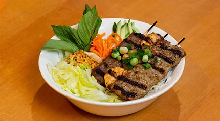 Vermicelli noodle bowl with grilled beef skewers, shrimp, shredded lettuce, basil and pickled carrots at Saigon #1, a Vietnamese restaurant in Virginia Beach