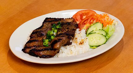 Grilled pork rice plate with steamed white rice, tomato, cucumber and pickled shredded vegetables at Saigon #1, a Vietnamese restaurant in Virginia Beach