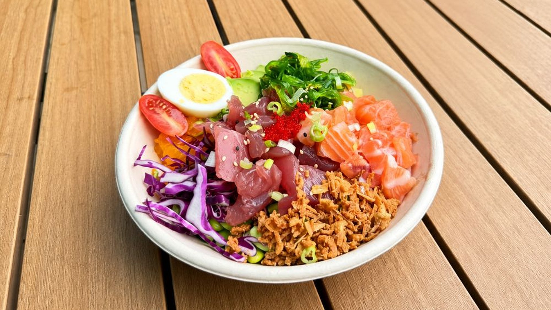 Salmon tuna poke bowl with assorted fresh toppings at Sakana Western, a Hawaiian Restaurant in Chicago