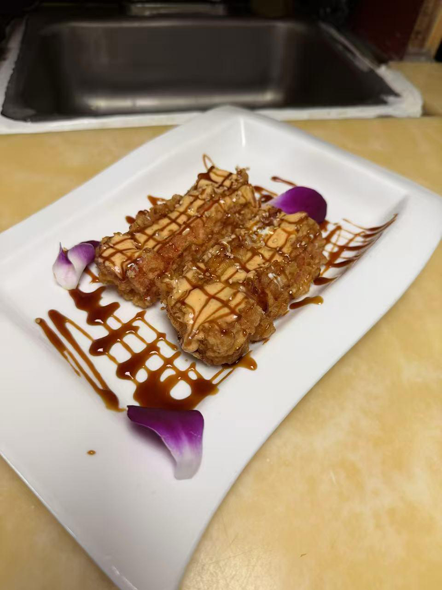 Fried appetizer with two sauces and purple flower petals at Sake House 2，a Japanese Restaurant in Jacksonville