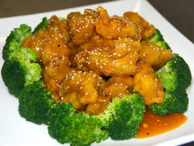 Lightly battered fried chicken, wok tossed in sesame sauce, served with steamed broccoli at Sakura Home，a Japanese Restaurant in Rochester