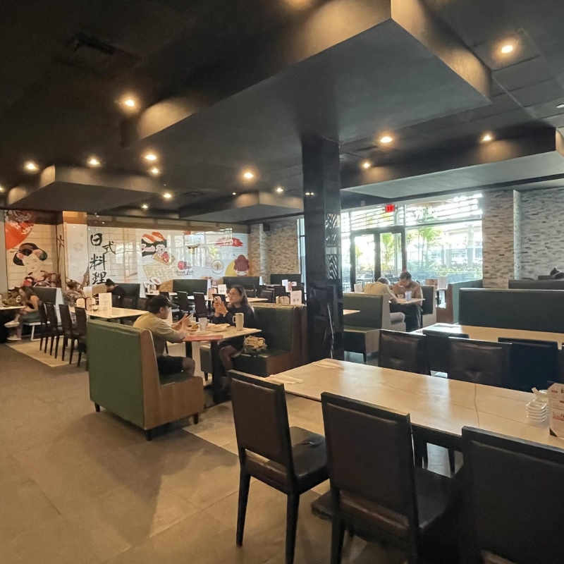 Indoor dining area with seated guests and booth seats at Sakura Sushi & Hibachi, a Japanese Restaurant in Kapolei