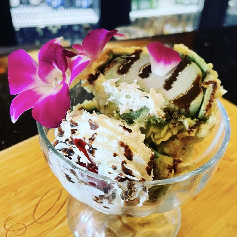 Matcha fried ice cream dessert with cream and orchid decor