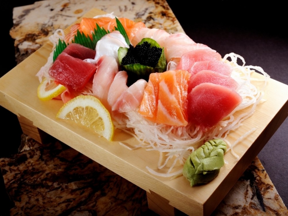 Luxury mixed sashimi on wooden serving board at Sakura Sushi & Hibachi, a Japanese Restaurant in Kapolei