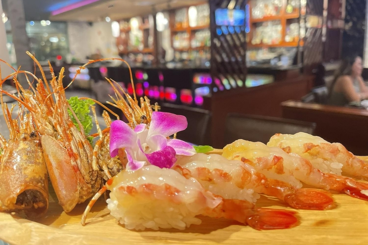 Premium spot prawn nigiri sushi with orchid garnish at Sakura Sushi & Hibachi, a Japanese Restaurant in Kapolei