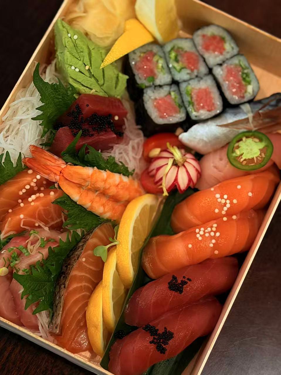 Sushi bento box with assorted sashimi and rolls at Sakura Sushi 88, a Japanese Restaurant in New York