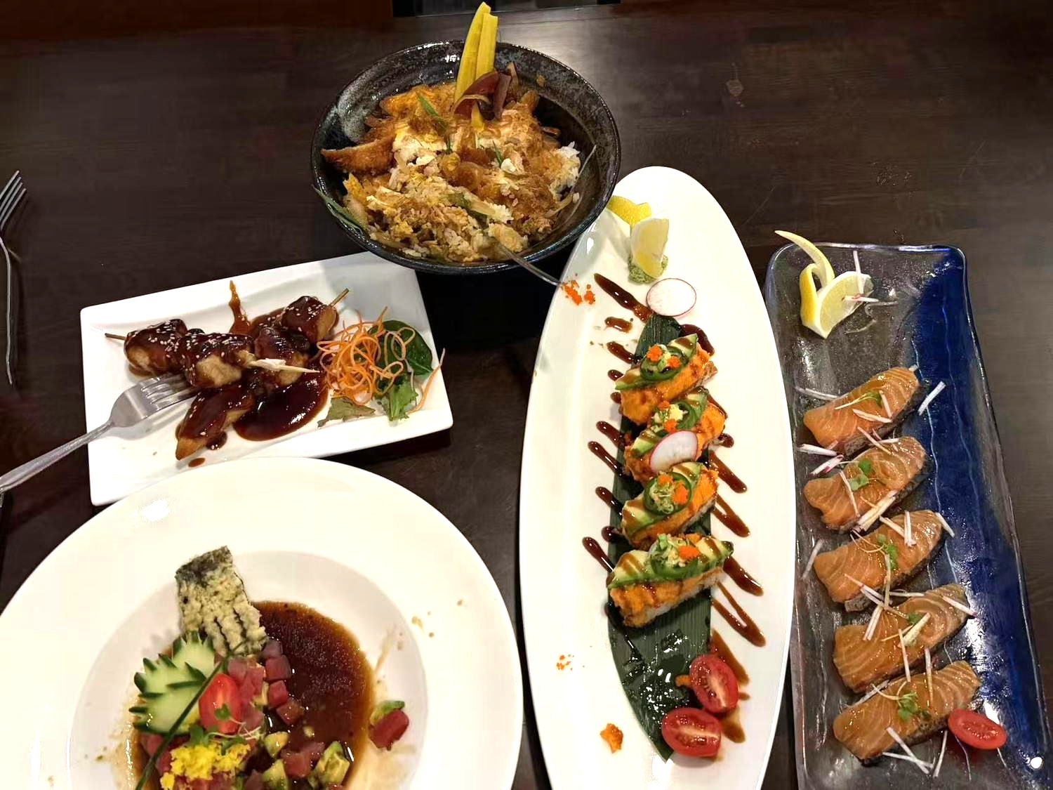 Assorted Japanese dishes including sushi and yakitori at Sakura Sushi 88, a Japanese Restaurant in New York