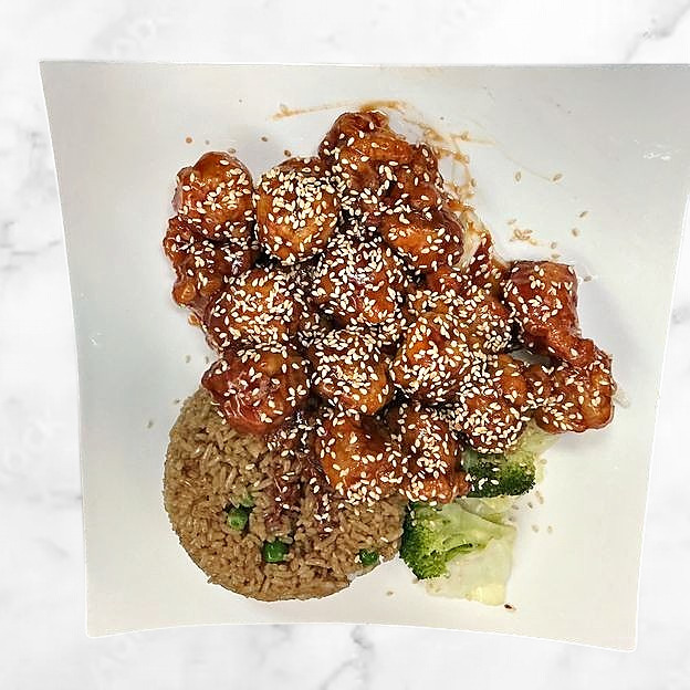 Sesame chicken with fried rice and veggies at Sakura Teriyaki, a Japanese Restaurant in South Orange Village