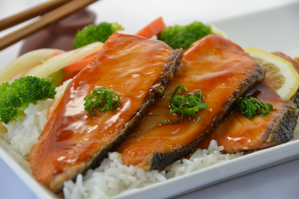 Grilled salmon teriyaki fillets over steamed rice at Sakura Teriyaki, a Japanese Restaurant in NJ
