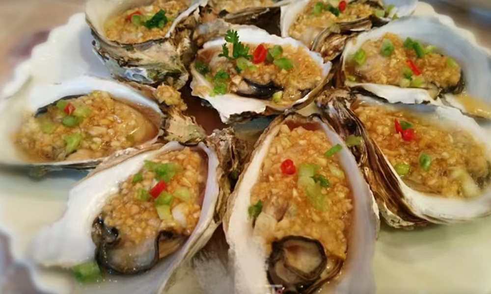 Baked oysters topped with garlic butter and herbs at Crab Seafood House-Sanford, a Seafood Restaurant in Sanford