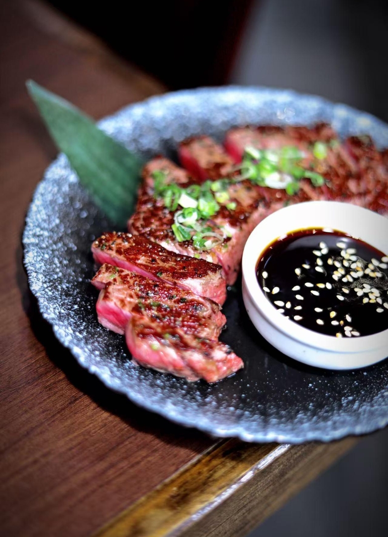 Grilled beef slices with scallions and dipping sauce at Sapporo Izakaya, a Japanese Restaurant in The Woodlands