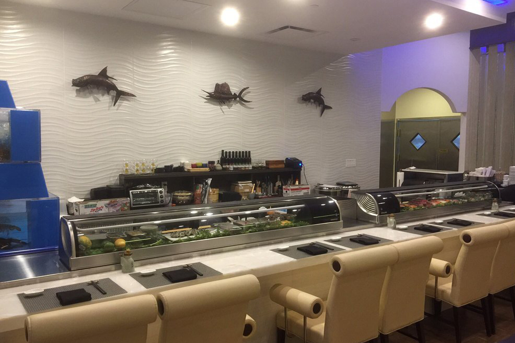 Sushi bar with seafood displays and comfortable chairs at Sasa, a Japanese Restaurant in Farmingdale.