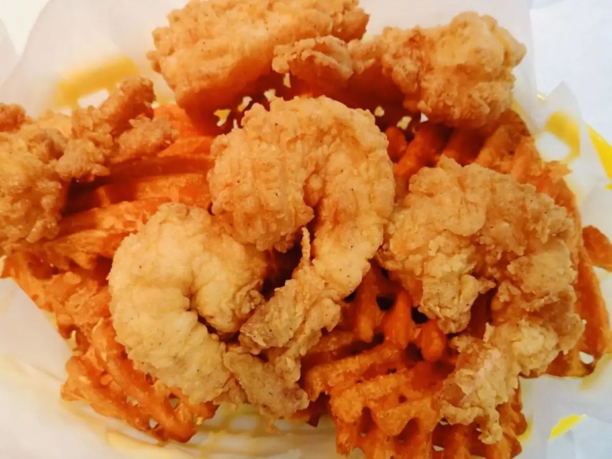 Fried shrimp paired with sweet potato fries for a satisfying combo at SAT Asian Seafood Restaurant & Bar in San Antonio