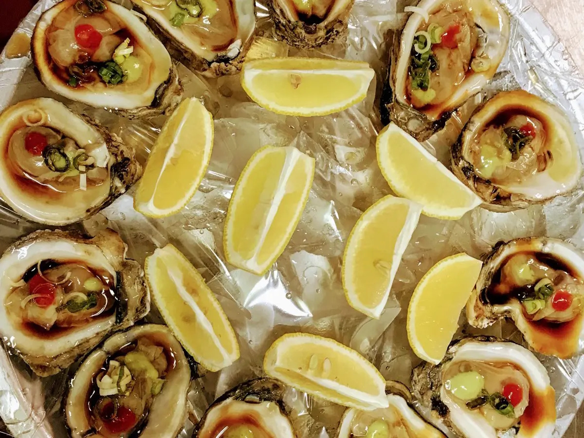 Oysters garnished with lemon slices and sauces at SAT Asian Seafood Restaurant & Bar in San Antonio