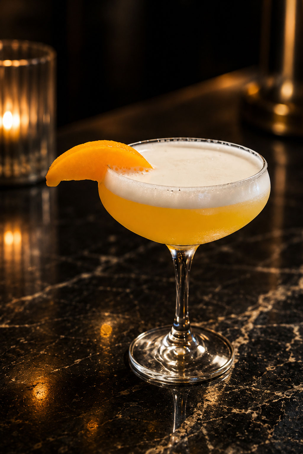 Creamy orange frosted cocktail topped with fresh peach slice in stemmed coupe glass at Sat Asian Seafood Restaurant &Bar, a Asian Restaurant in Oklahoma City