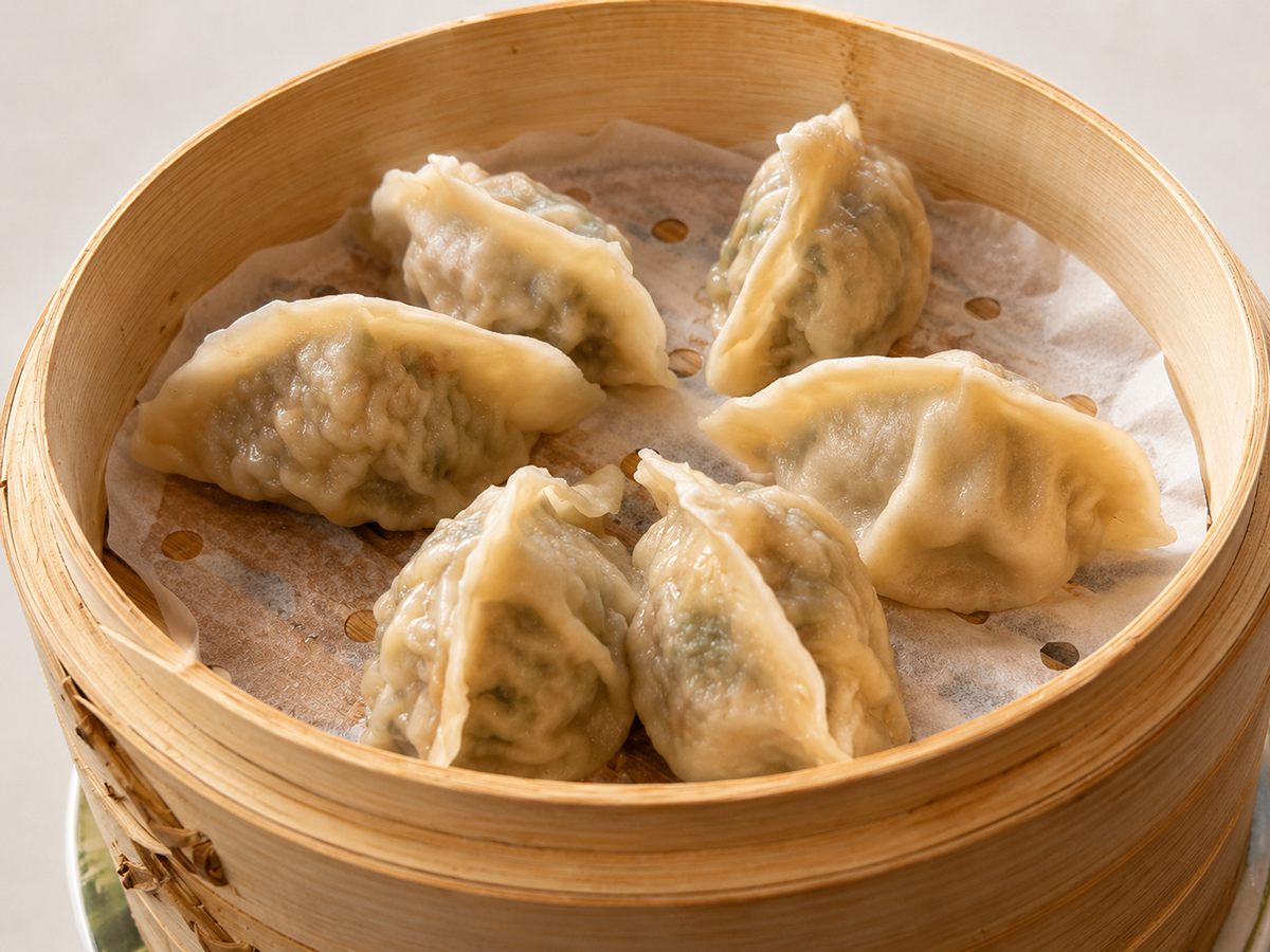 Steamed dumplings arranged in a bamboo basket at Savory Bun, a Chinese Restaurant in Roselle