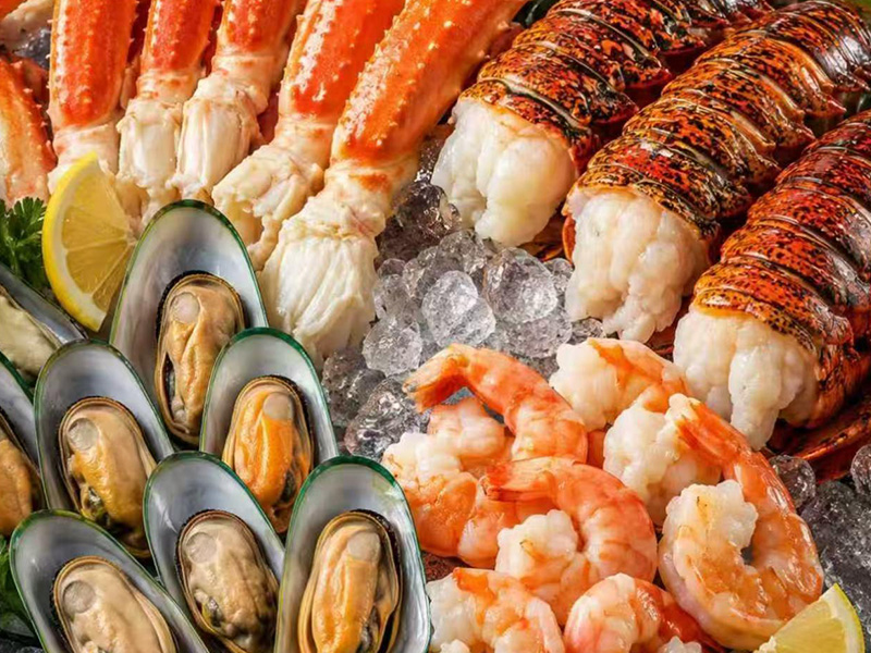 Raw seafood platter with king crab legs, lobster tails, mussels, shrimp on ice with lemon at Seafood&wings, a Seafood Restaurant in Greenville