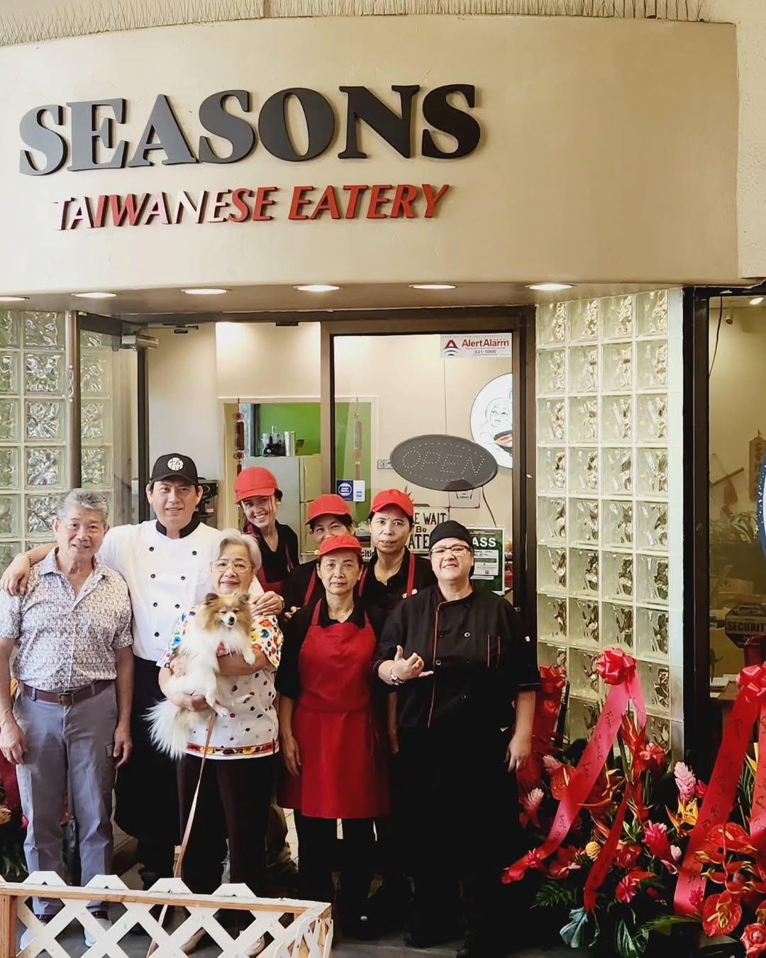 People in front of "SEASONS TAIWANESE EATERY" storefront