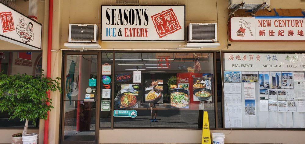 Seasons-Taiwanese-Eatery-Taiwanese-Restaurant-Exterior-Honolulu Street view of restaurant facade with 'SEASON'S ICE & EATERY' sign, red Chinese characters ' 秀兰小馆 ', glass window with food photos and 'OPEN' sign, green plant on left at Seasons Taiwanese Eatery,a Taiwanese Restaurant in Honolulu