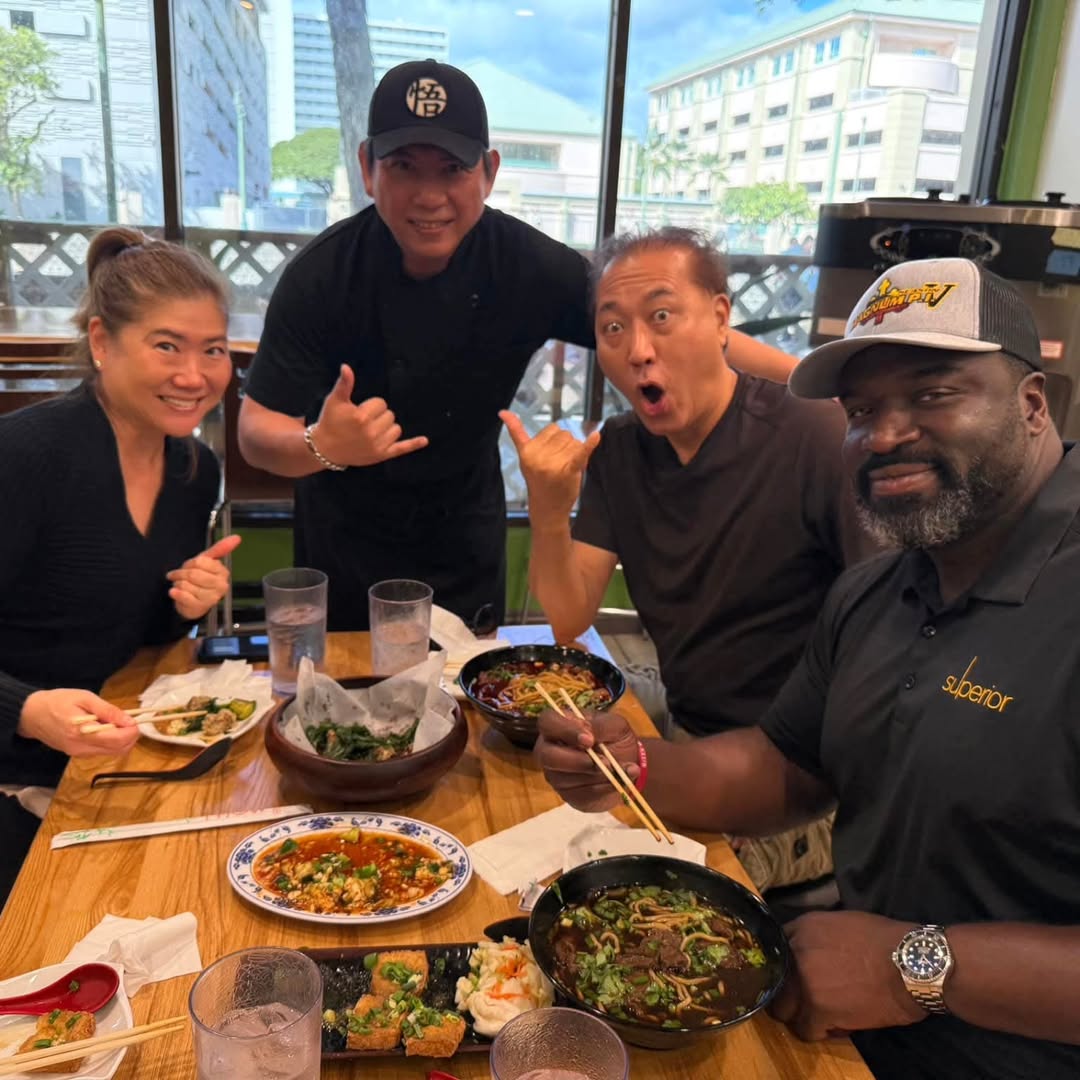 Group enjoying meals at a wooden table in the eatery at Seasons Taiwanese Eatery，a Taiwanese Restaurant in Honolulu