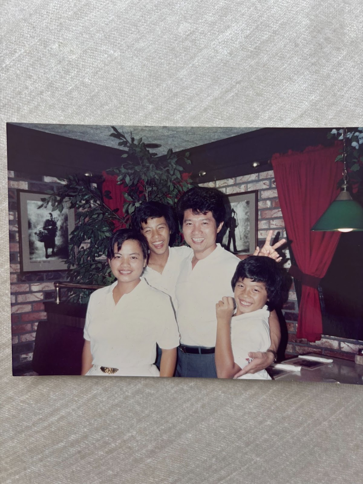 Four people posing in restaurant interior at Seasons Taiwanese Eatery，a Taiwanese Restaurant in Honolulu