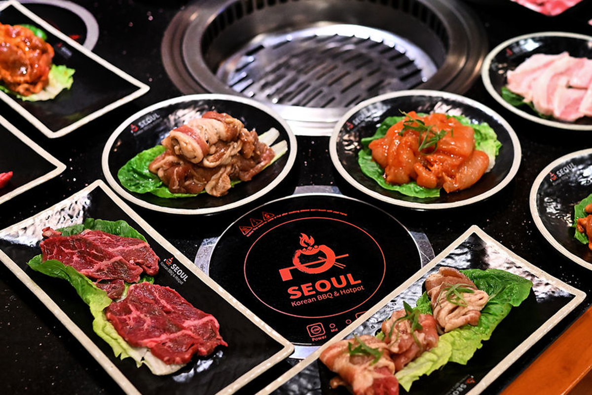 A selection of marinated meats on plates at Seoul Korean BBQ & Hotpot，a Korean Restaurant in Mason
