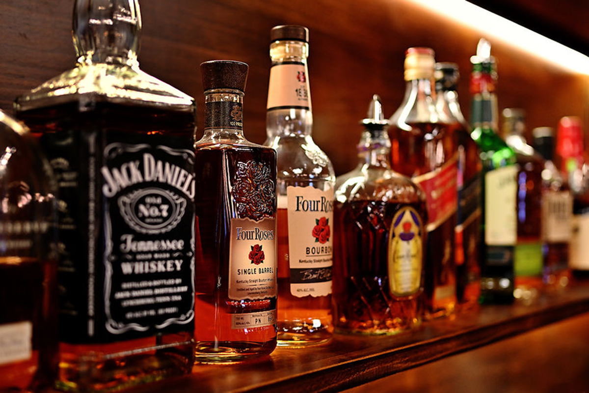A variety of whiskey bottles on a shelf at Seoul Korean BBQ & Hotpot，a Korean Restaurant in Mason
