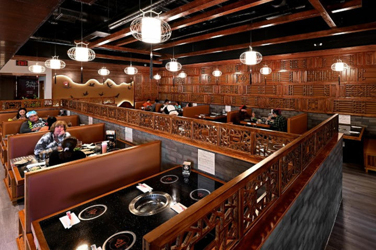 The interior of the Seoul Korean BBQ & Hotpot restaurant with customers seated