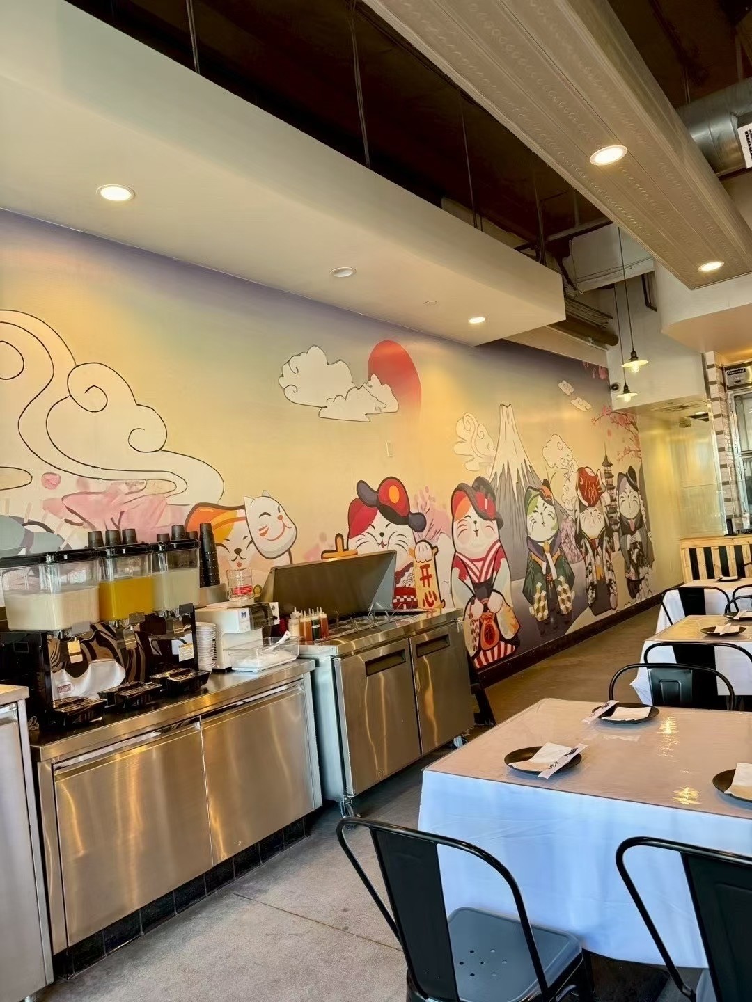 Dining area with mural & hot pot setup.