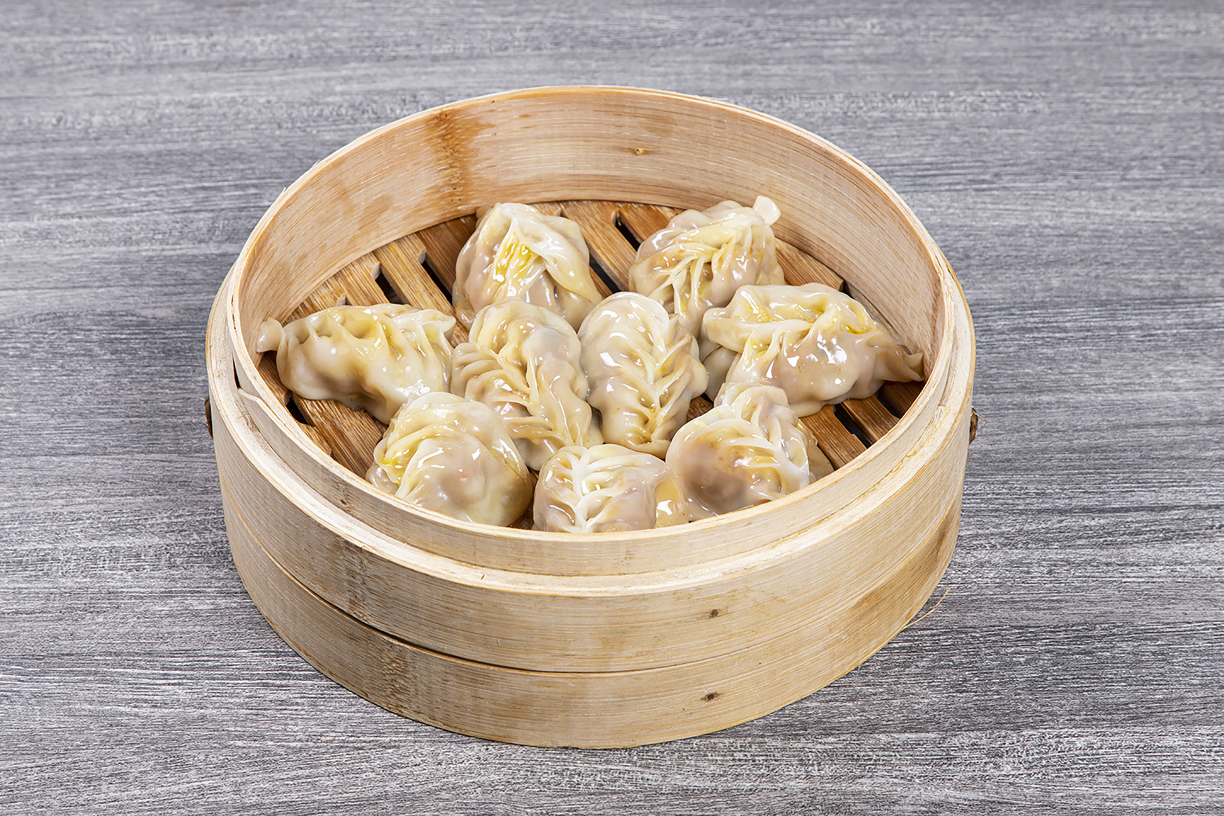 Handmade juicy steamed dumplings in bamboo steamer at Shaxian Snacks, a Chinese Restaurant in Elmhurst