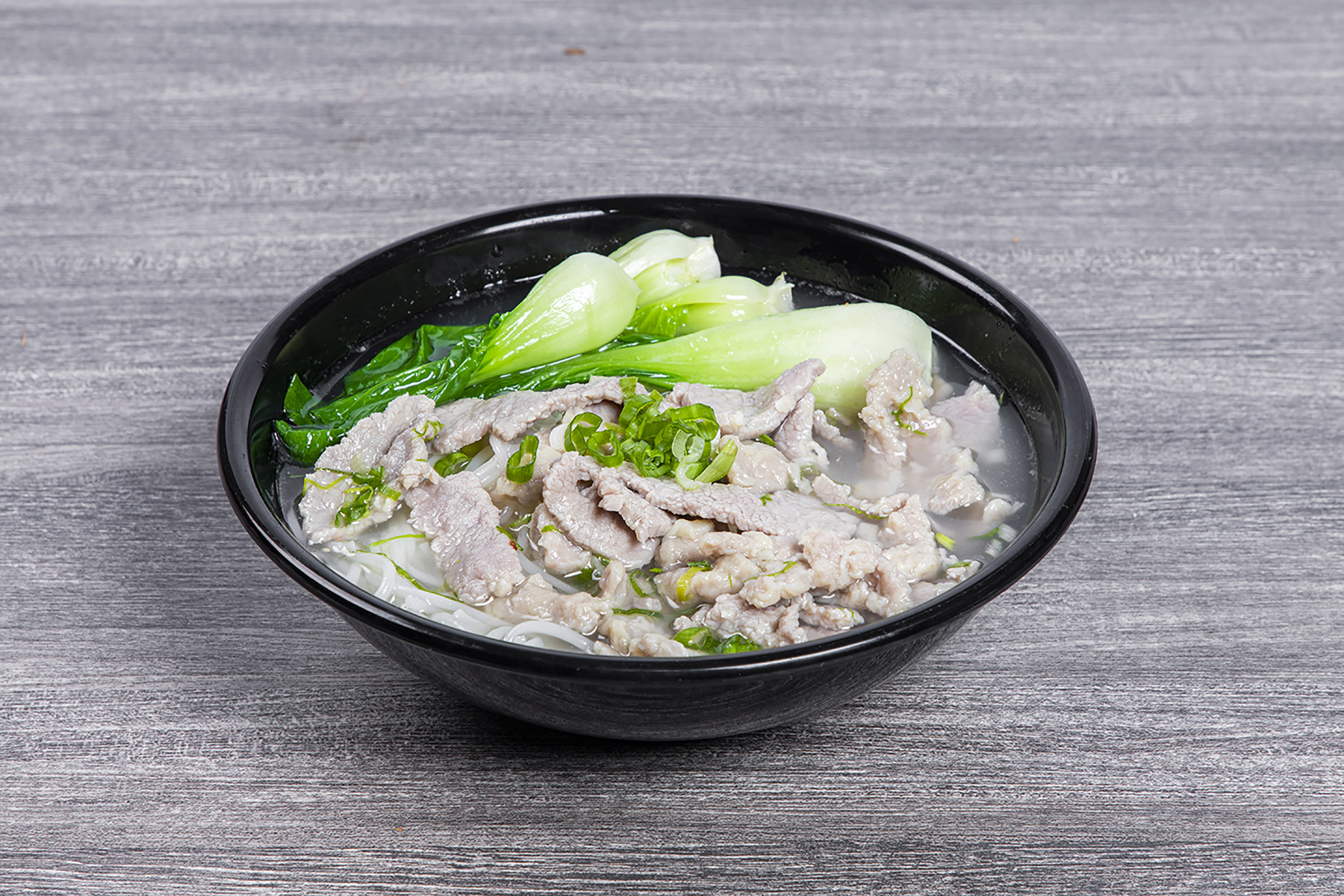 Sliced pork rice noodle soup with baby bok choy and green onion at Shaxian Snacks, a Chinese Restaurant in Elmhurst