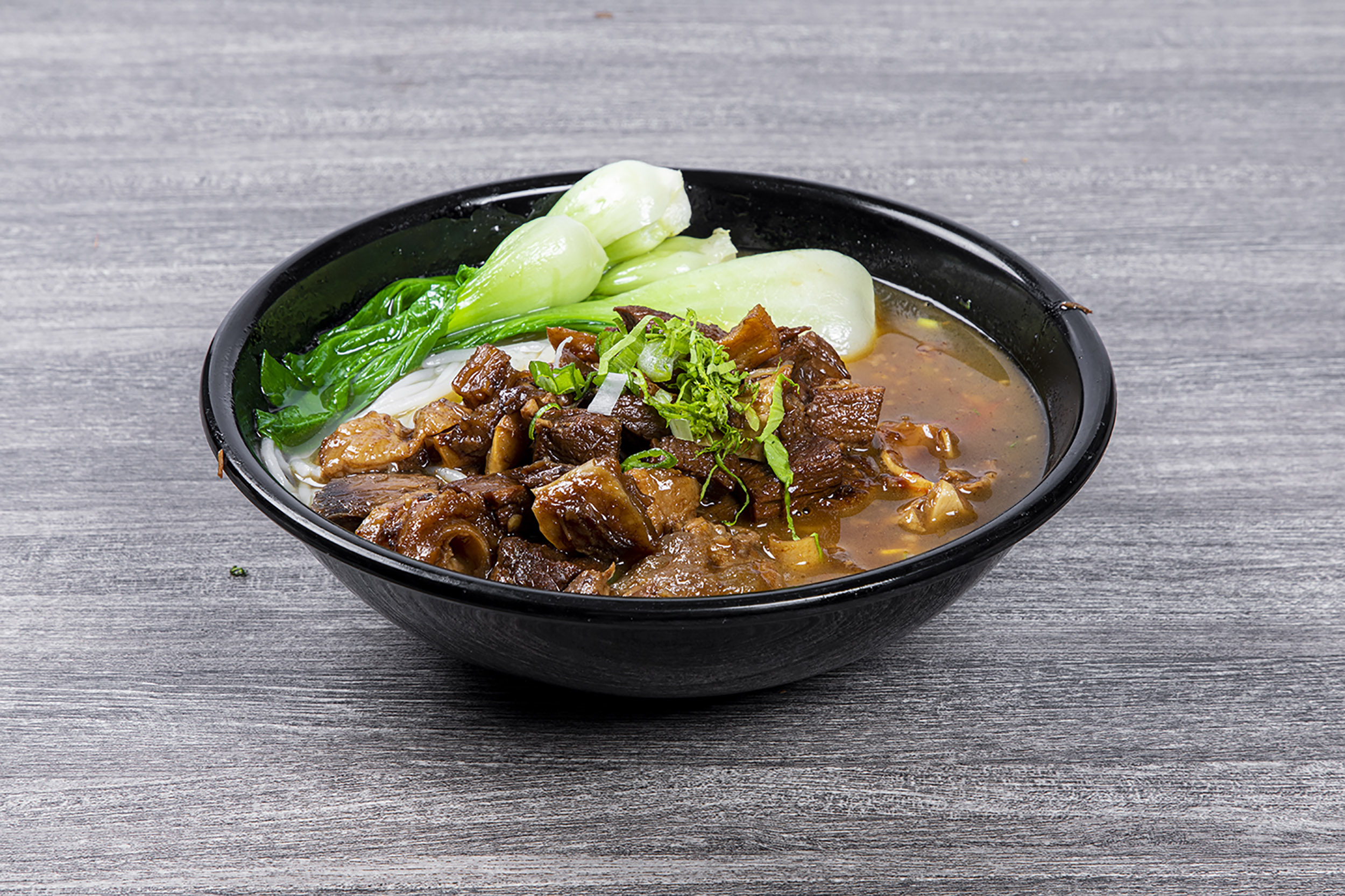 Beef brisket rice noodle soup with fresh baby bok choy at Shaxian Snacks, a Chinese Restaurant in Elmhurst