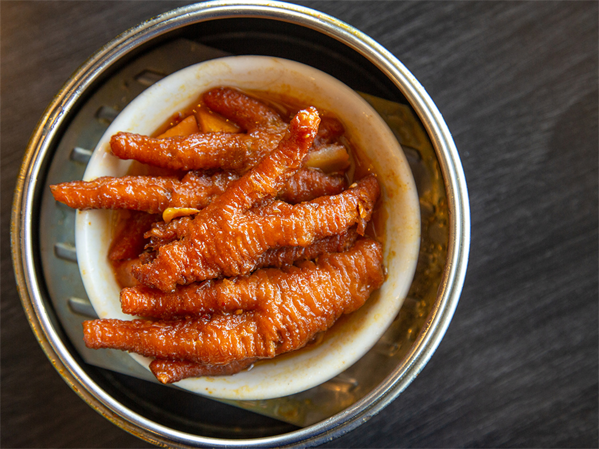Tender braised chicken feet in savory sauce, served in a steamer at Sheng Hui Dim Sum, a Chinese Dim sum restaurant in West Covina