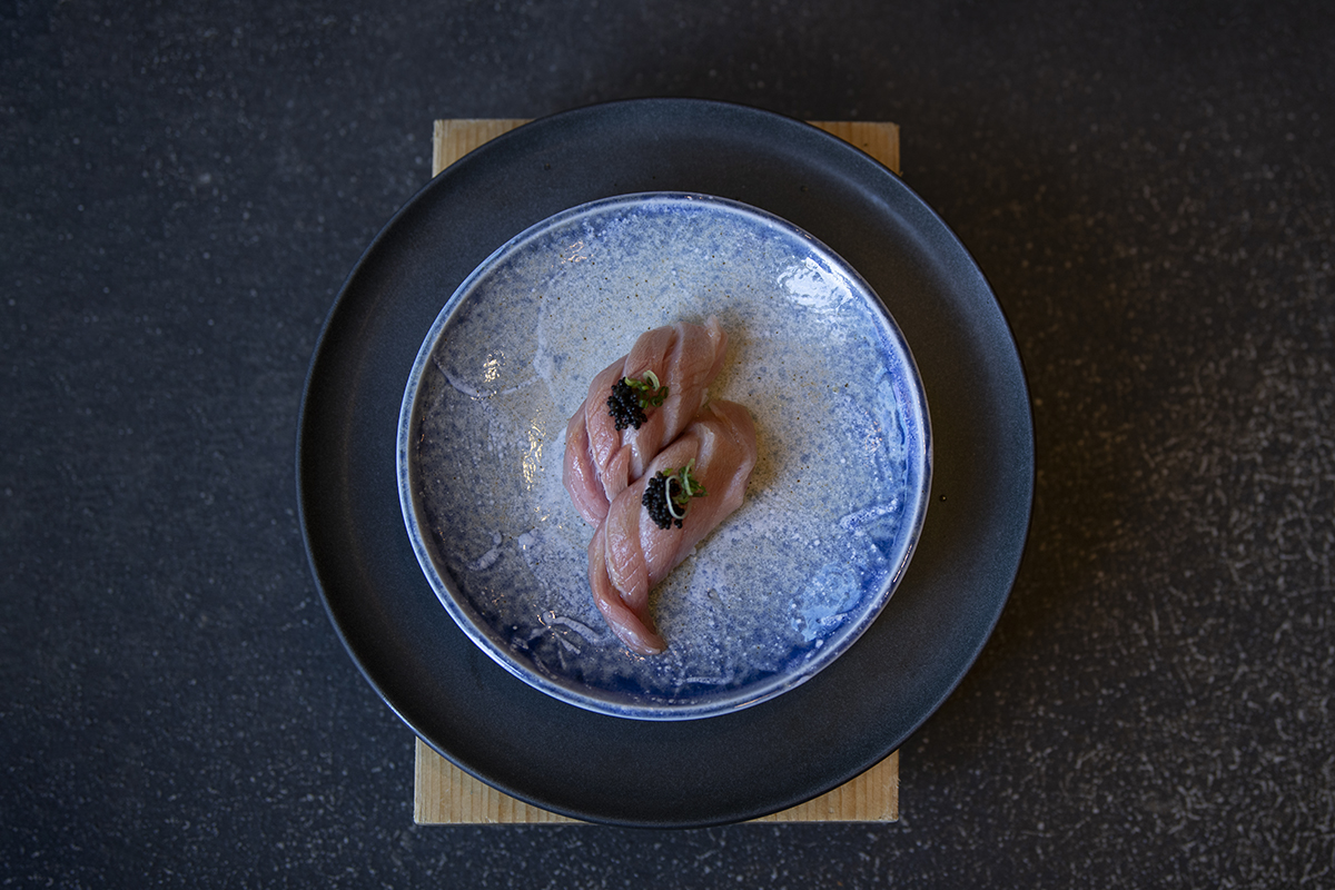 Tuna sashimi slices topped with caviar on a blue plate at Shiki Sushi，a Japanese Restaurant in Santa Rosa