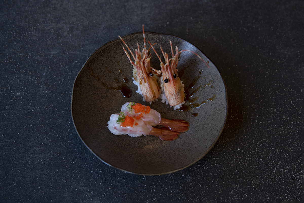 Grilled and raw shrimp sushi on a dark plate, topped with caviar at Shiki Sushi，a Japanese Restaurant in Santa Rosa
