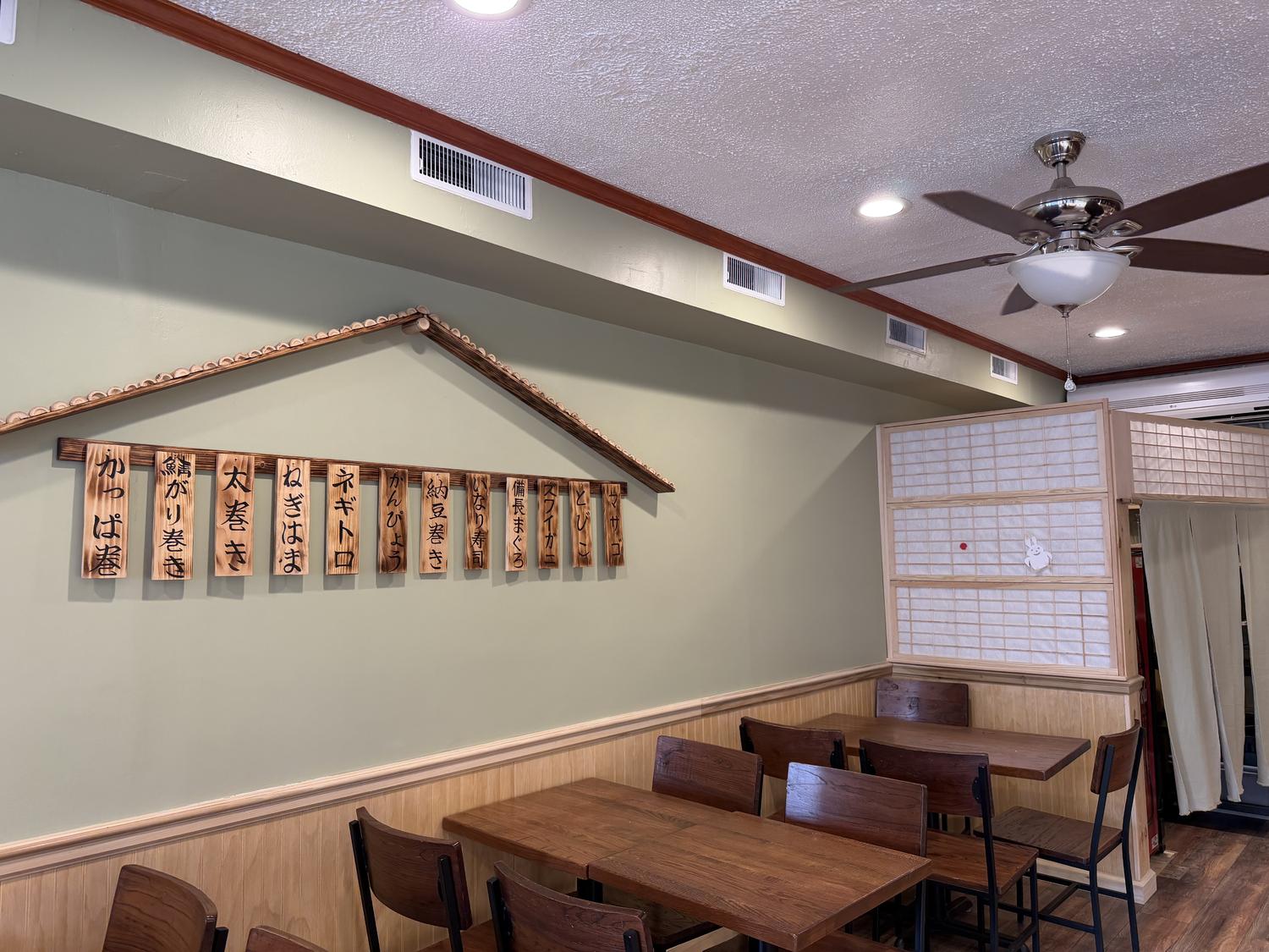 Spacious dining area with wooden tables and Japanese menu signs at Shogun, a Japanese Restaurant in Rutherford