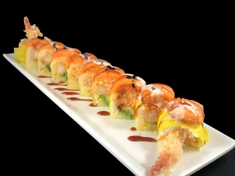 Shrimp tempura roll topped with salmon and assorted sauces at Shoku Sushi & Bar, a Japanese Restaurant in Monroe