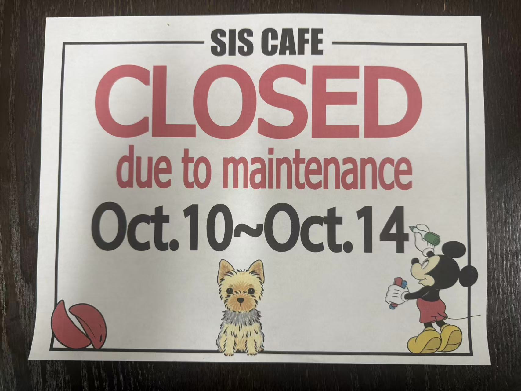 SIS Cafe closed for maintenance Oct 10–14, white paper sign on glass door.