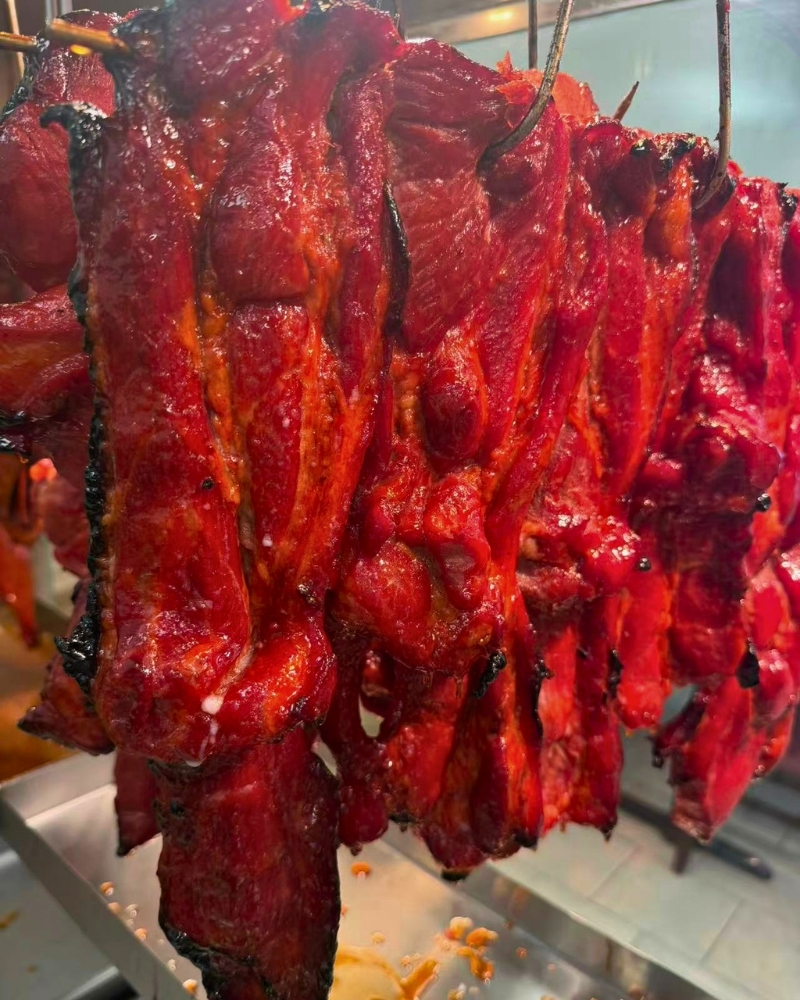 Close-up of glossy honey glazed char siu pork at Siu Lap City, a Chinese Restaurant in Houston