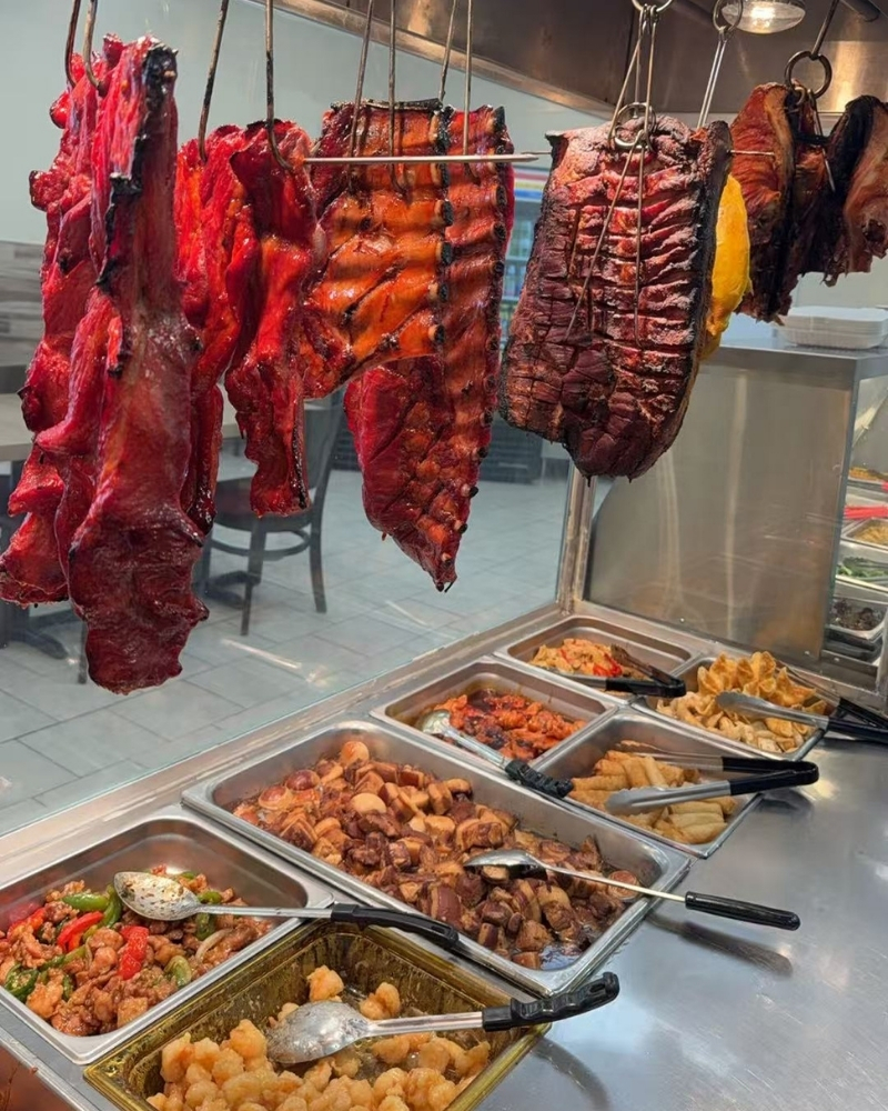 Hanging char siu and assorted hot dishes at Siu Lap City, a Chinese Restaurant in Houston