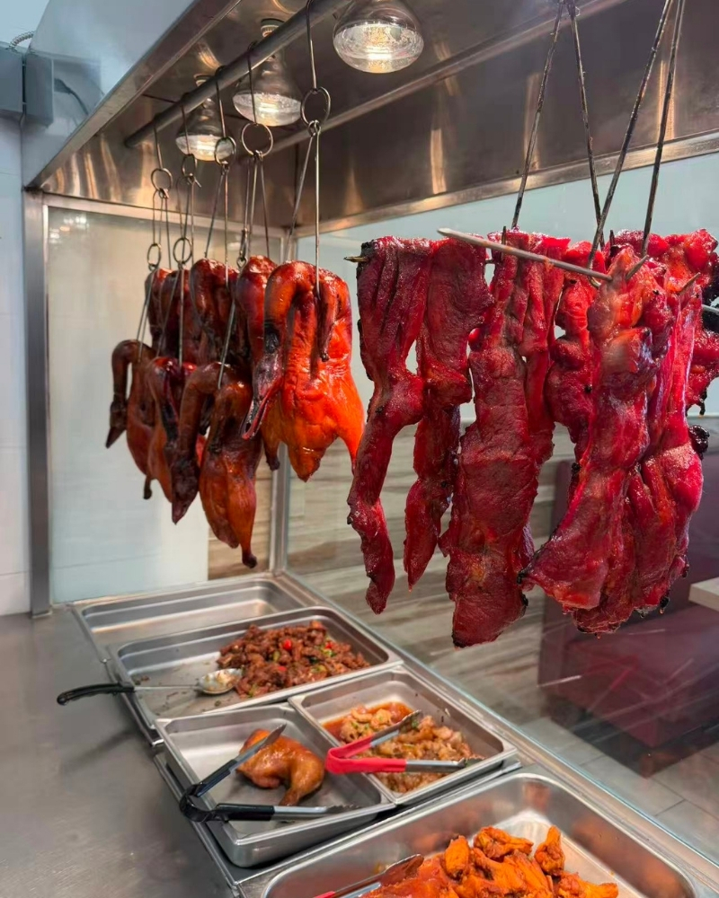 Roast ducks and char siu hanging in display window at Siu Lap City, a Chinese Restaurant in Houston