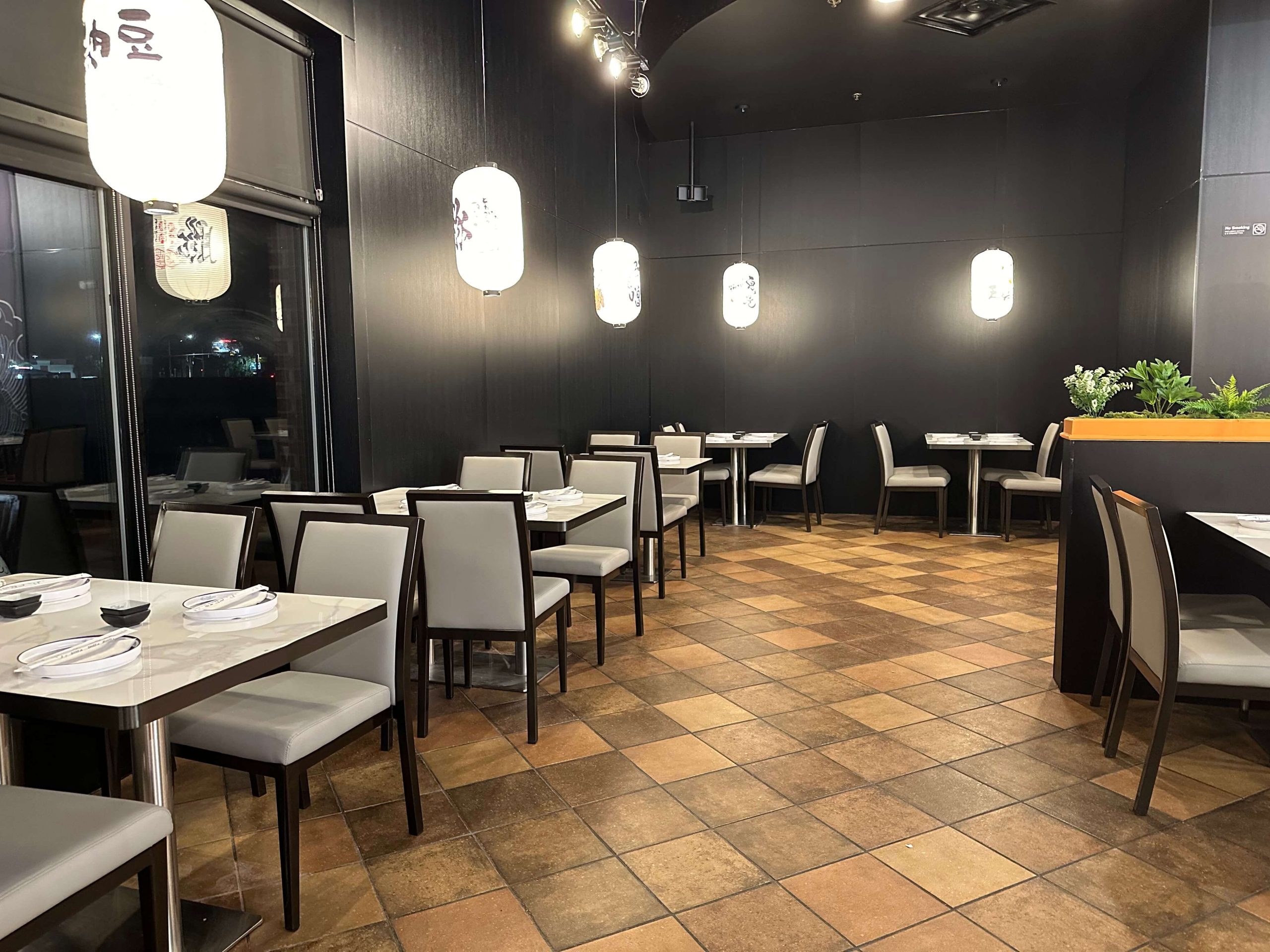 Sushi-Kingdom-Japanese-Restaurant-Dining-Area-1-Savannah Stylish dining area with dark walls and Japanese lanterns at Sushi Kingdom, a Japanese Restaurant in Savannah