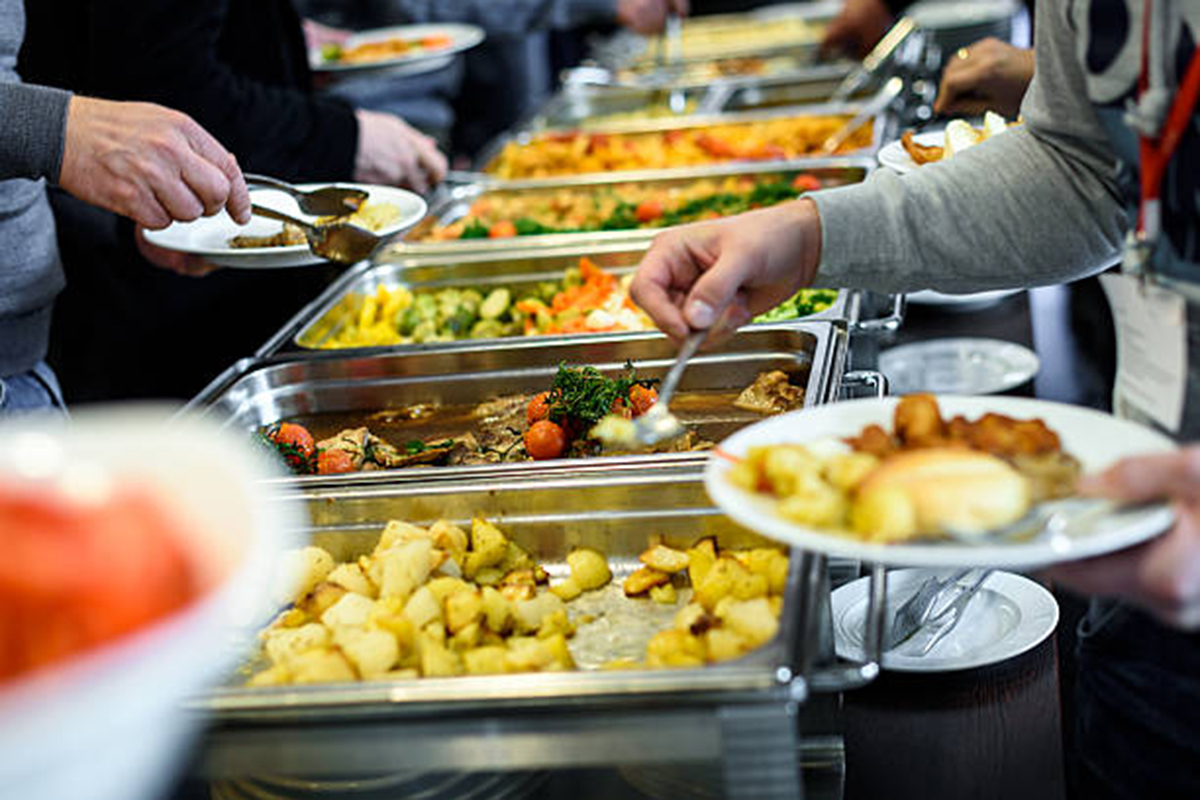 SL-Asian-Food-Buffet-Restaurant-Buffet-Dining-Scene-San-Antonio People serving themselves at a buffet with diverse dishes at SL Asian Food, a Buffet Restaurant in San Antonio