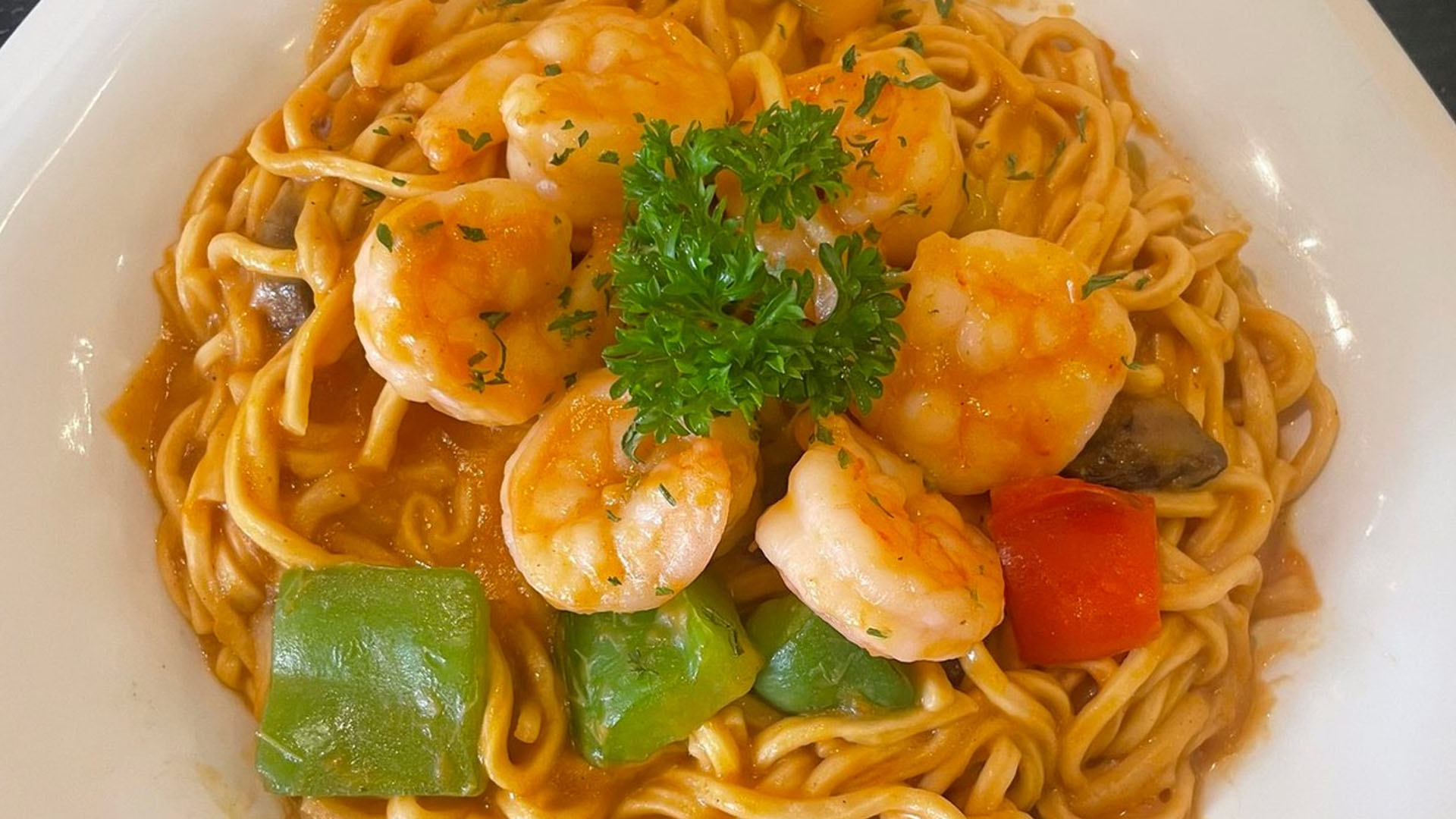 Spicy tomato prawn spaghetti mixed with bell pepper chunks at Smile House Cafe, a Hong Kong Style Fast Food Restaurant in San Francisco